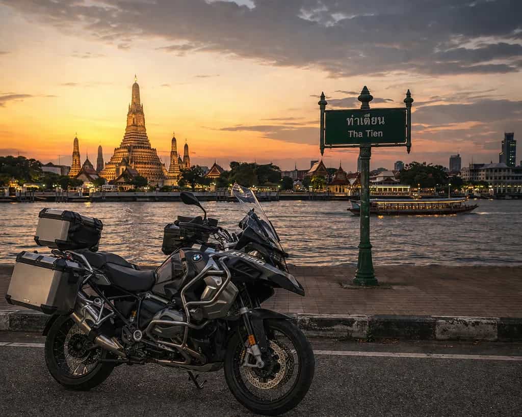 BMW adventure motorcycle at Wat Arun temple at sunset in Bangkok, Thailand: Byklo motorbike rental