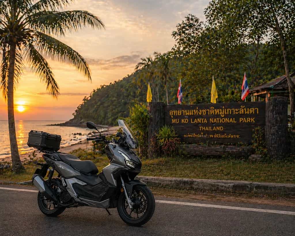 Adventure scooter at the Mu Ko Lanta National Park sign on Koh Lanta, Thailand: Byklo scooter rental