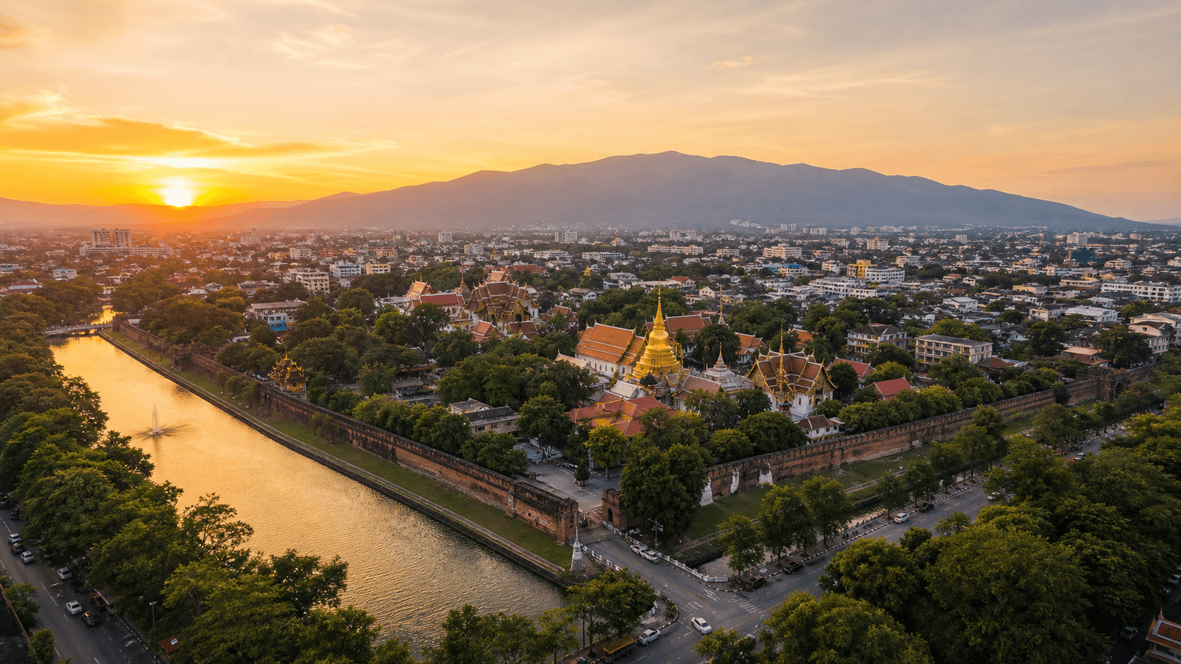 Aerial view of Chiang Mai’s Old City with golden temple spires at sunset
