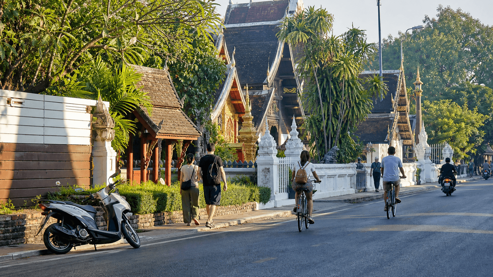 Cyclists riding in Chiang Mai's Old City with traditional temples