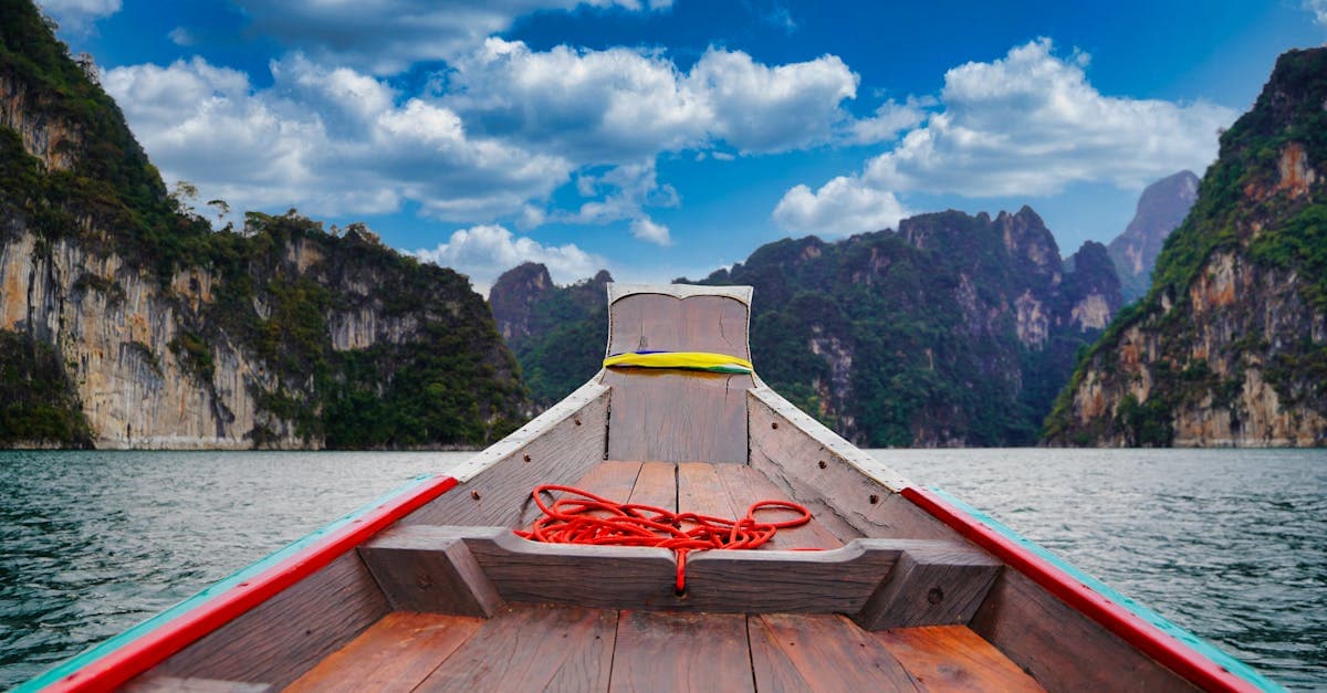 A peaceful boat ride through the scenic limestone cliffs of Khao Sok National Park, Thailand.