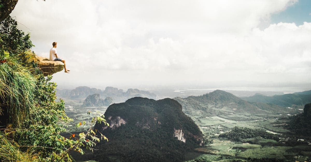 Adventure seeker enjoys a breathtaking view from a cliff in Krabi, Thailand.