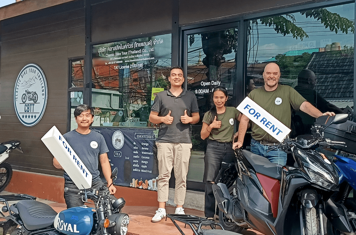 People standing outside motorbike rental shop in Chiang Mai. Byklo employee and owners and staff of Classic Bike Tour Thailand outside the motorbike rental shop
