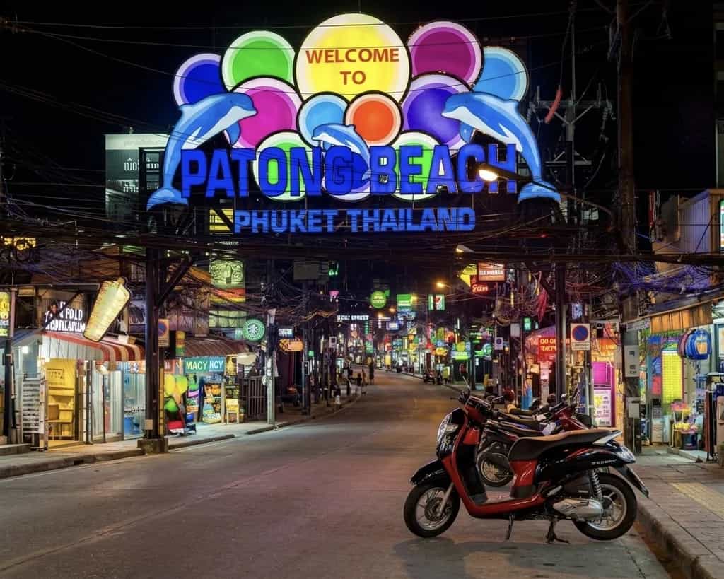 Honda Scoopy scooter at the Patong Beach welcome arch in Phuket, Thailand: Byklo motorbike rental